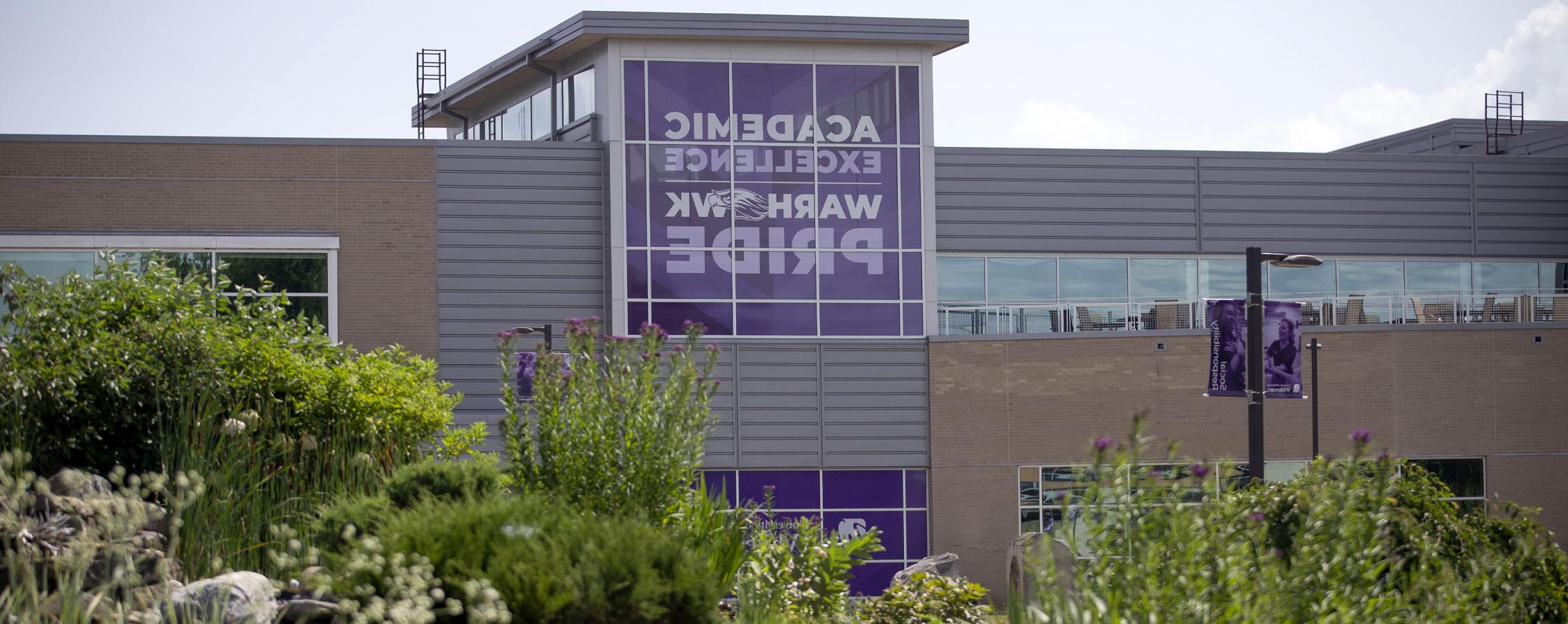 The University Center with a purple banner that says Academic Excellence and Warhawk Pride.